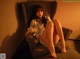 A woman sitting in a chair with her legs crossed.